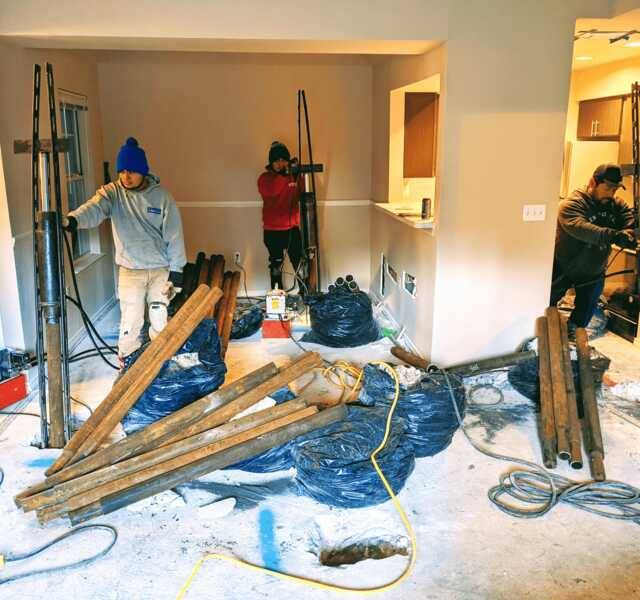Quality Foundation Repair Austin team installing hydraulic push piers for residential foundation repair.