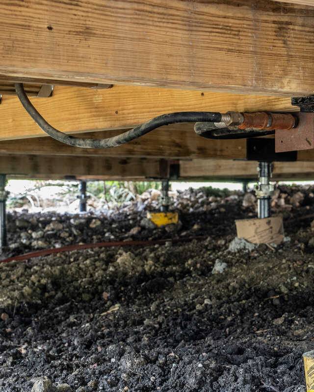 Quality Foundation Repair Austin installing adjustable steel piers for crawl space isolated pier and beam foundation leveling