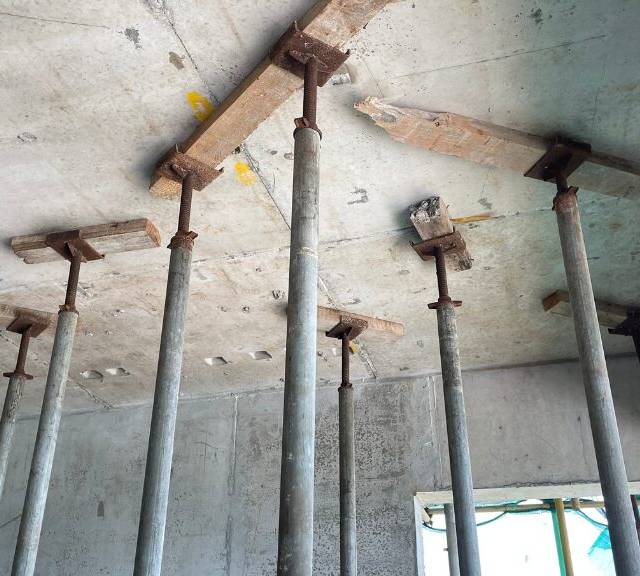 Quality Foundation Repair Austin steel support posts carrying a concrete slab during structural repair.